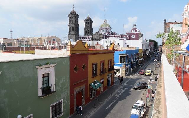 Colourful houses along a street leading to the towers of Puebla Cathedral, seen from the Museo Amparo terrace