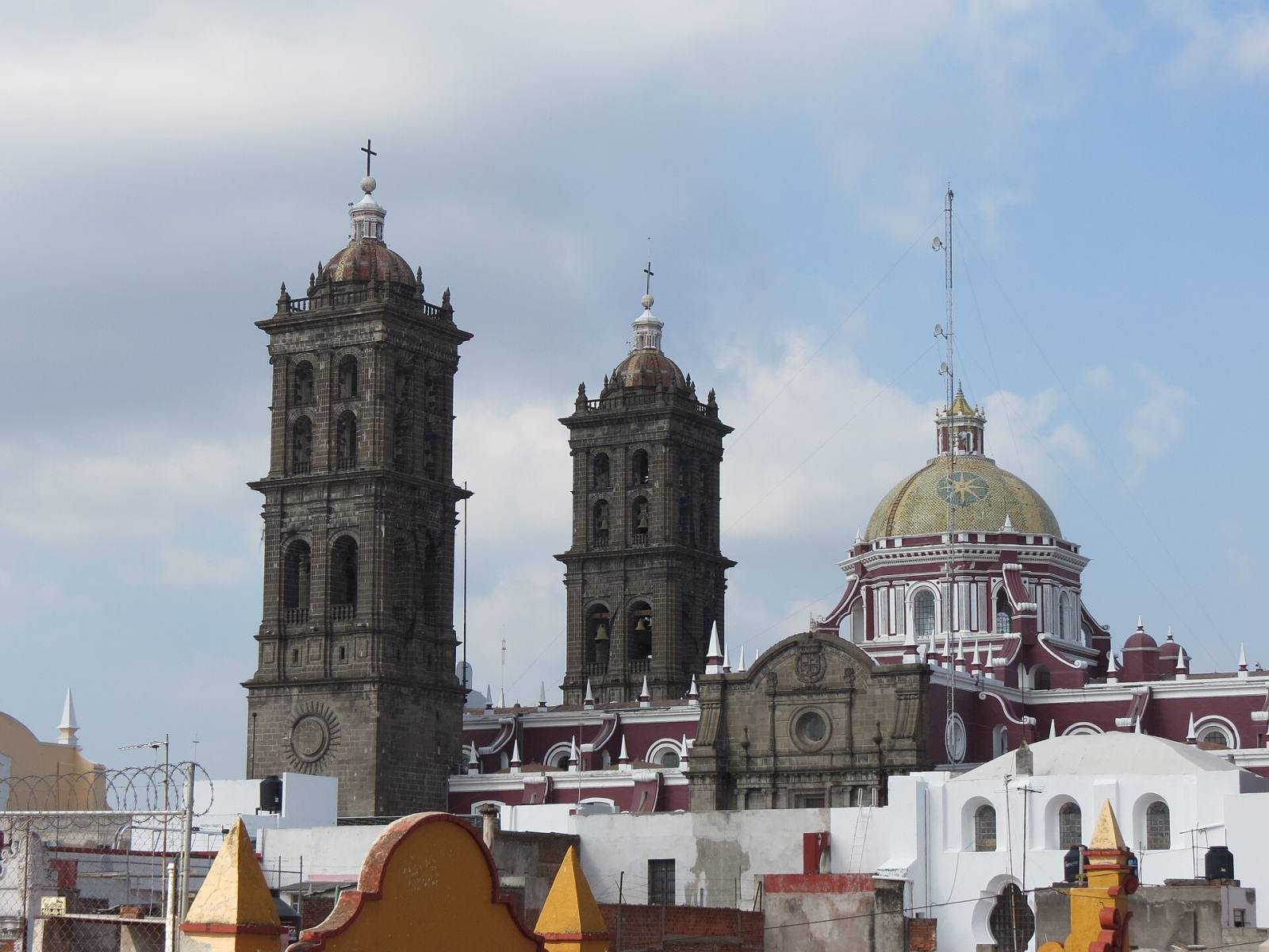 The bell towers and tiled dome of Puebla Cathedral above the rooftops of the historic centre
