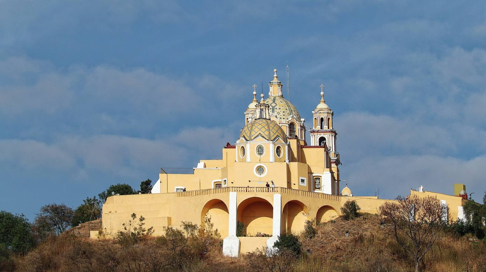 The yellow Sanctuary of Our Lady of Remedies on top of the Great Pyramid of Cholula