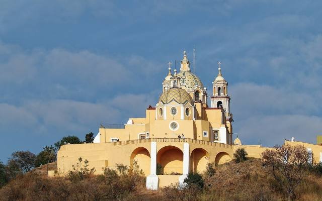 The yellow Sanctuary of Our Lady of Remedies on top of the Great Pyramid of Cholula